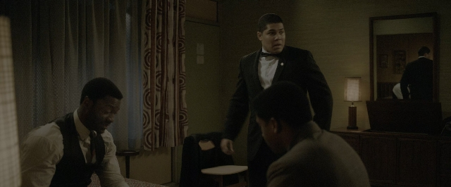 Wide shot frame from One Night in Miami — sitting, standing, room