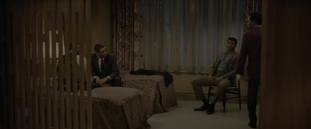 Wide shot frame from One Night in Miami — sitting, standing, room