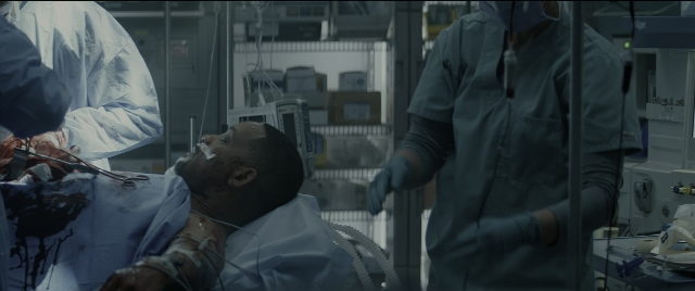 Wide shot frame from Bad Boys for Life — room, bed, coat