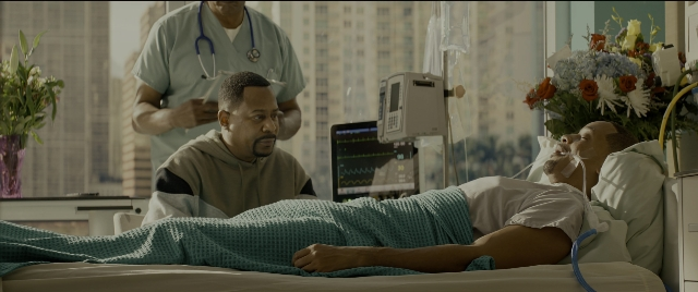 Wide shot frame from Bad Boys for Life — standing, room, table