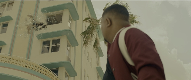 Wide shot frame from Bad Boys for Life — walking, bag, bird