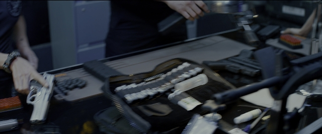 Wide shot frame from Bad Boys for Life — table, hand, shirt