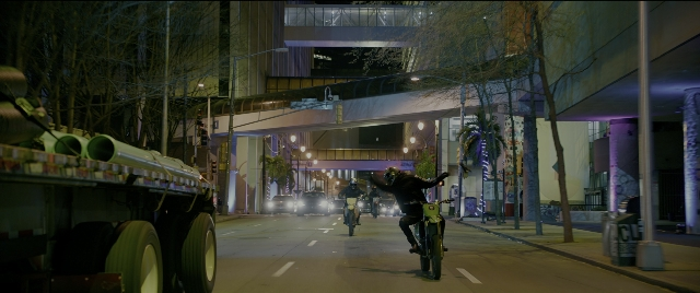 Wide shot frame from Bad Boys for Life — street, night, bicycle