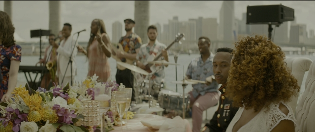 Wide shot frame from Bad Boys for Life — sitting, standing, table