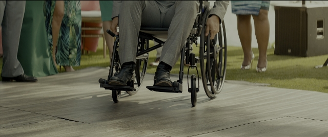 Wide shot frame from Bad Boys for Life — walking, table, suit