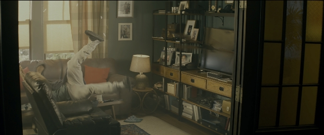Wide shot frame from Bad Boys for Life — sitting, book, room