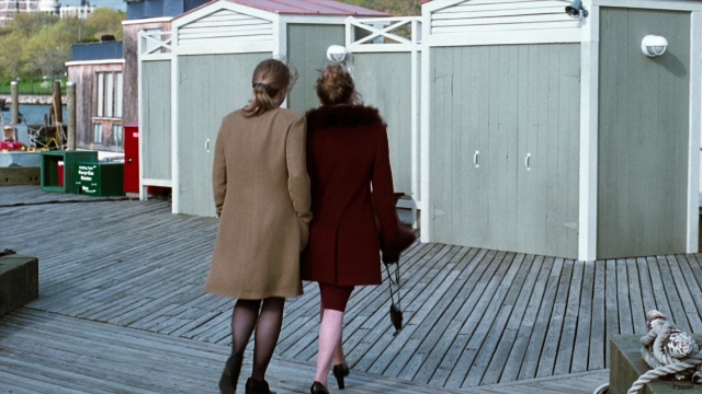 Wide shot frame from You've Got Mail — walking, coat, water