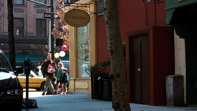 Wide shot frame from You've Got Mail — walking, door, street