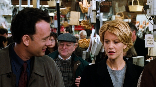 Medium shot frame from You've Got Mail — standing, walking, hat