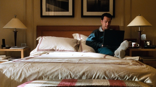 Wide shot frame from You've Got Mail — sitting, room, bed