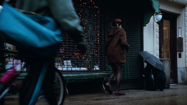 Medium shot frame from You've Got Mail — walking, door, street