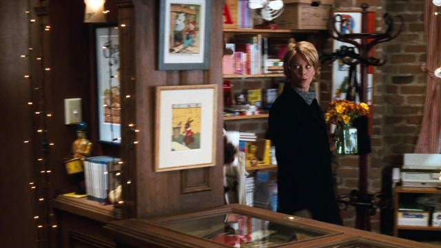Wide shot frame from You've Got Mail — book, standing, room