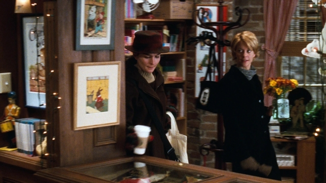 Wide shot frame from You've Got Mail — standing, room, hat
