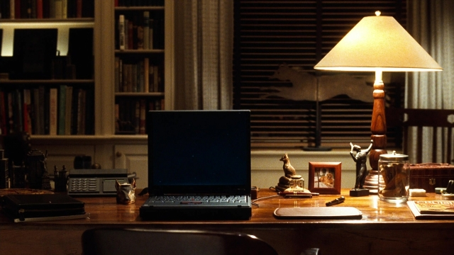 Wide shot frame from You've Got Mail — desk, book, room