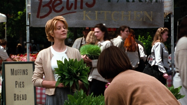 Medium shot frame from You've Got Mail — standing, kitchen, hair