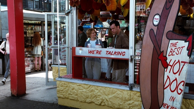Wide shot frame from You've Got Mail — standing, walking, dialogue