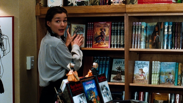 Wide shot frame from You've Got Mail — book, standing, hair
