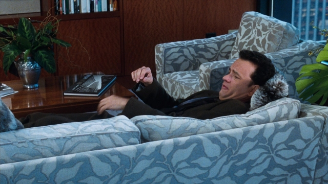 Wide shot frame from You've Got Mail — sitting, book, room
