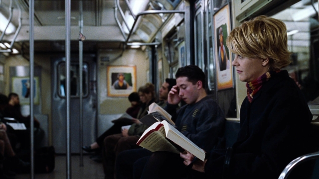 Wide shot frame from You've Got Mail — sitting, book, coat