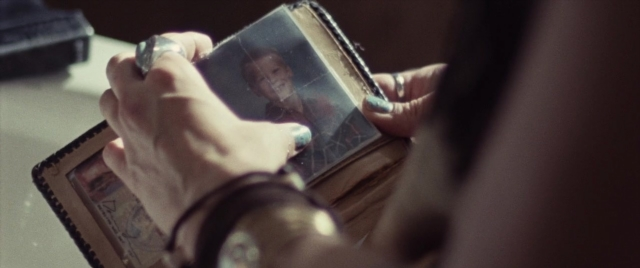 Frame from Supremacy — sitting, book, table