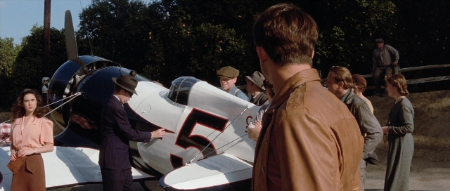 Wide shot frame from The Rocketeer — standing, hat, suit