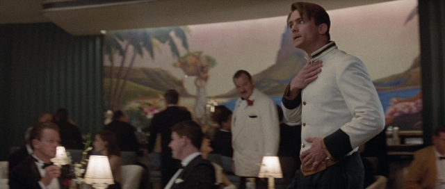 Wide shot frame from The Rocketeer — sitting, standing, room
