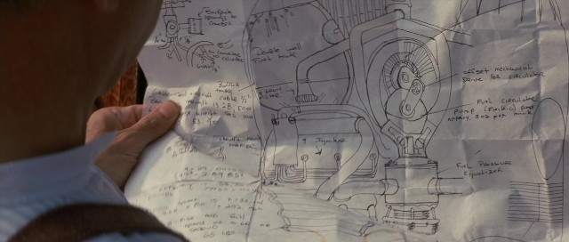 Wide shot frame from The Rocketeer — car, hand, face
