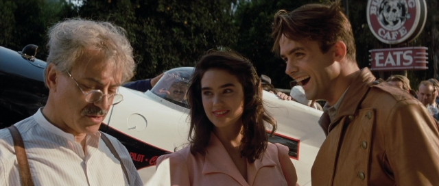 Wide shot frame from The Rocketeer — standing, car, coat