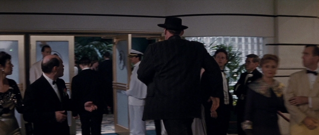 Wide shot frame from The Rocketeer — standing, room, door