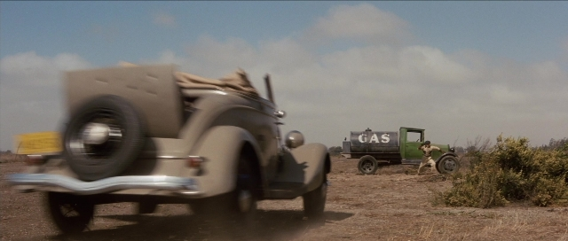 Wide shot frame from The Rocketeer — walking, street, car