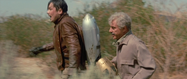 Wide shot frame from The Rocketeer — walking, street, hat