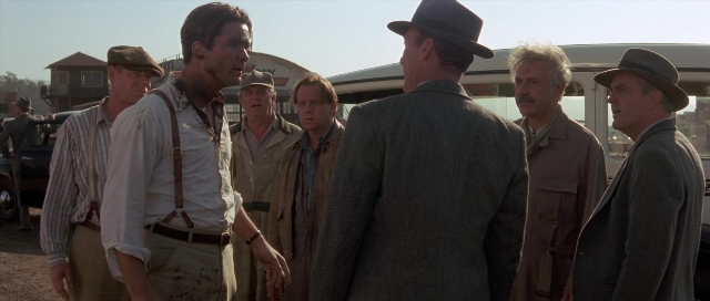 Wide shot frame from The Rocketeer — standing, dialogue, street