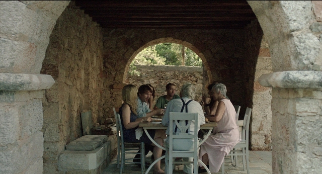 Wide shot frame from Before Midnight — sitting, table, dialogue