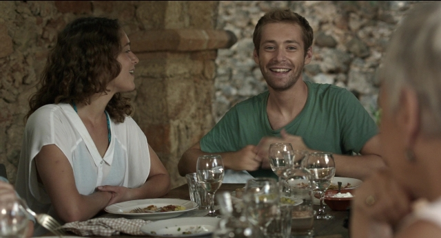 Wide shot frame from Before Midnight — sitting, table, dialogue