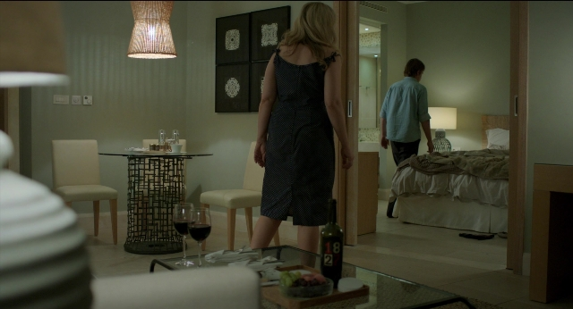 Wide shot frame from Before Midnight — standing, table, bed