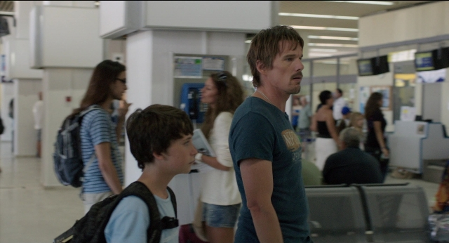 Wide shot frame from Before Midnight — standing, shirt, face