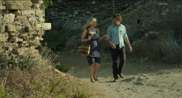 Wide shot frame from Before Midnight — walking, dialogue, shirt