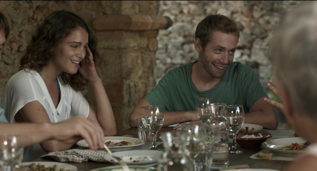 Medium shot frame from Before Midnight — sitting, room, table
