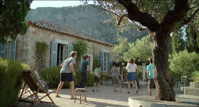Wide shot frame from Before Midnight — walking, house, chair
