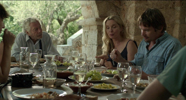 Wide shot frame from Before Midnight — sitting, plate, table