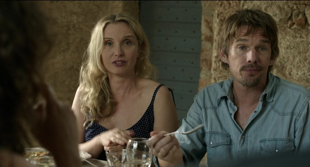 Wide shot frame from Before Midnight — sitting, table, dress