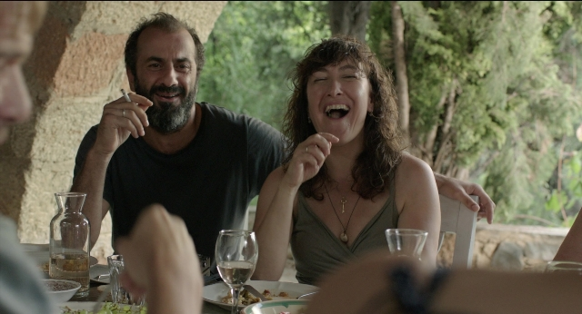 Wide shot frame from Before Midnight — sitting, table, dialogue