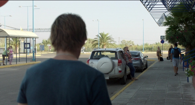 Wide shot frame from Before Midnight — walking, street, car