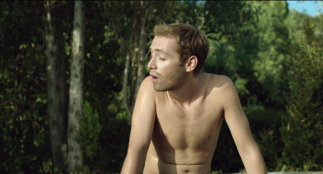 Wide shot frame from Before Midnight — sitting, shirt, beard