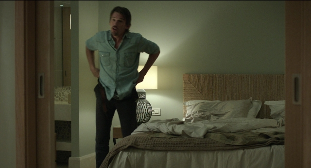 Wide shot frame from Before Midnight — standing, room, bed