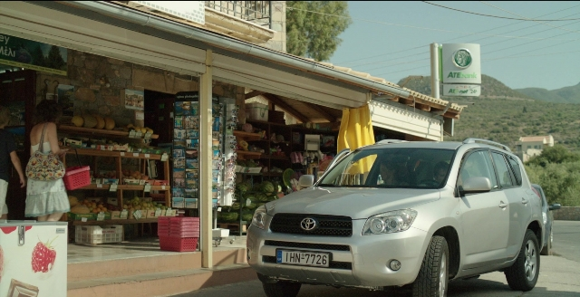 Wide shot frame from Before Midnight — standing, street, car