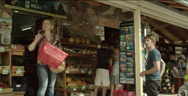 Wide shot frame from Before Midnight — standing, phone, hand