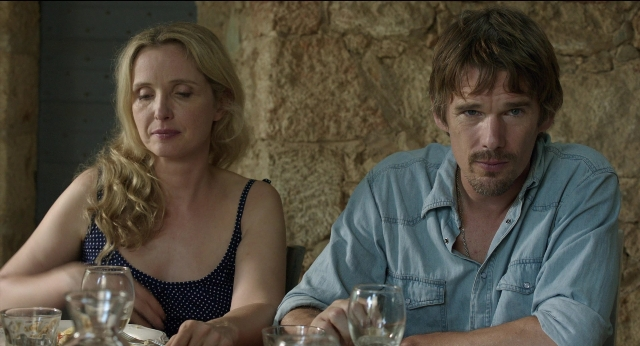 Medium shot frame from Before Midnight — sitting, table, dress