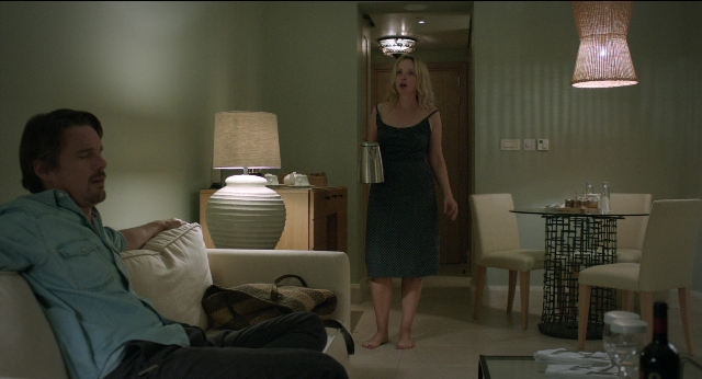 Medium shot frame from Before Midnight — sitting, standing, table