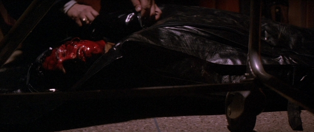 Wide shot frame from Die Hard 2 — room, shirt, face